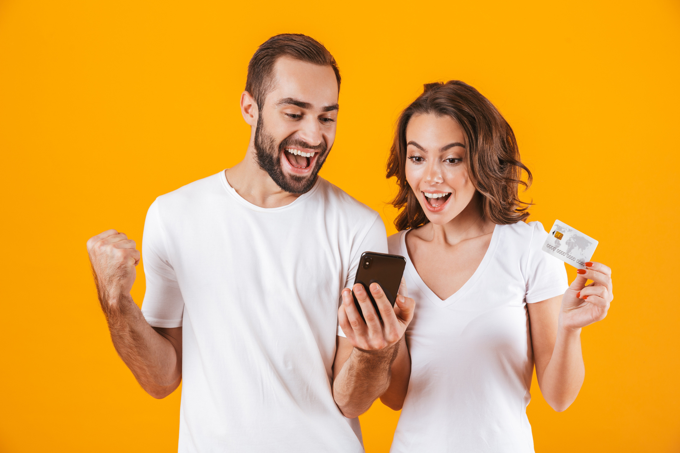Man and Woman Using Cell Phone and Credit Card