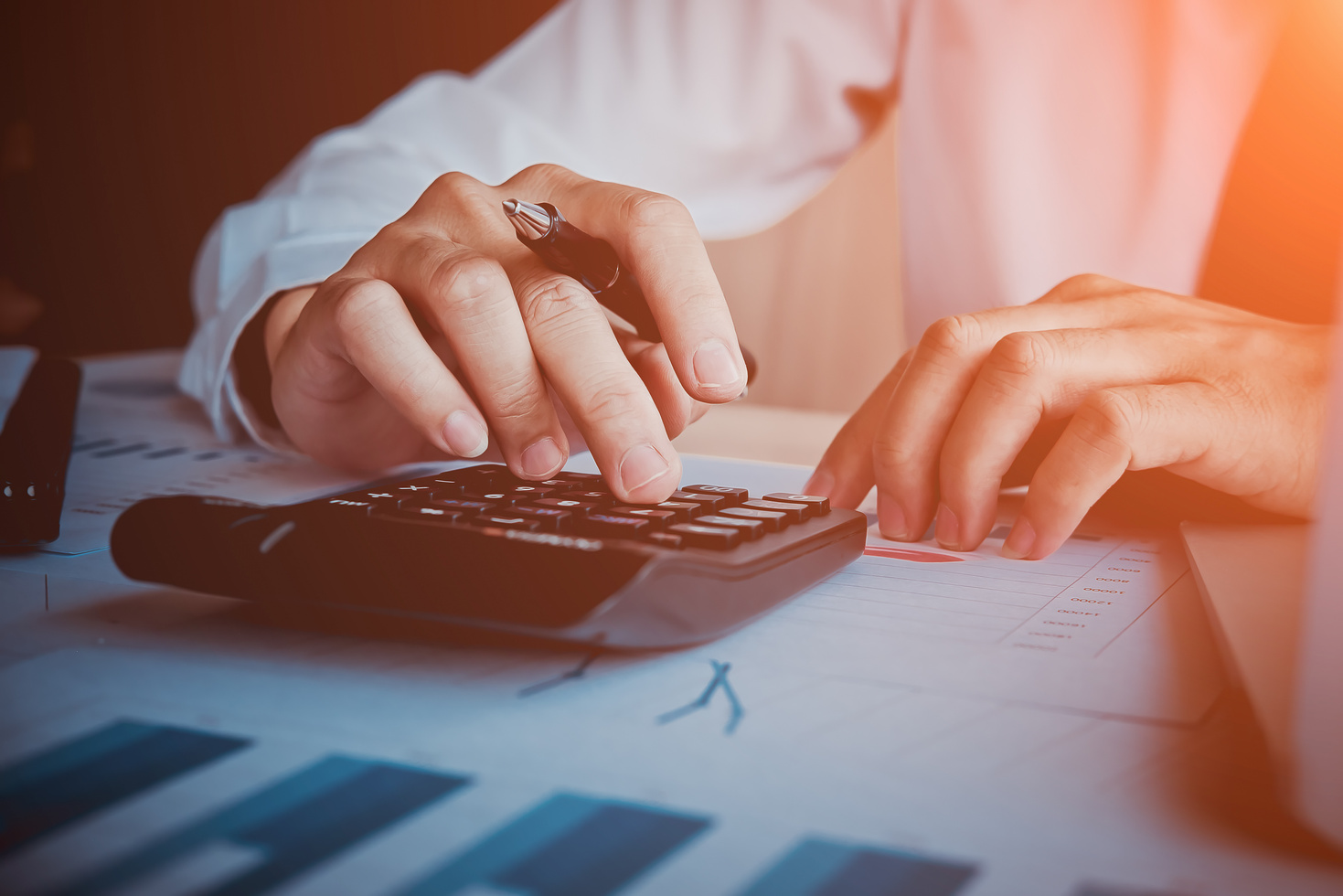 Close Up of Hands Using the Calculator